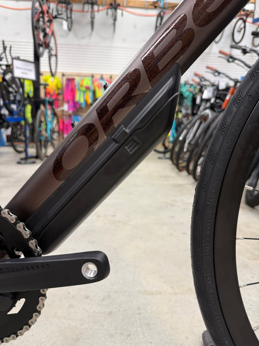 Close-up of a bicycle frame with a blurred background of other bicycles.