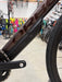 Close-up of a bicycle frame with a blurred background of other bicycles.