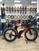 Red Hot Cervelo P5 Force AXS triathlon bike in a bike shop setting.