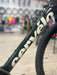 Close-up of a bicycle frame with 'Cervélo' branding in a bike shop setting.